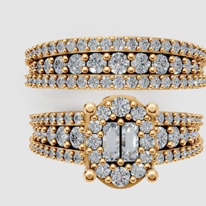 May include: A gold-colored ring set featuring a band and an engagement ring. The band has three rows of small, round, clear stones. The engagement ring has a central oval cluster of clear stones, flanked by two rectangular stones, and surrounded by smaller stones.