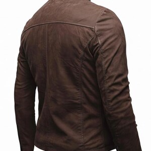May include: A brown jacket with a stand-up collar, long sleeves, and a back yoke seam. The garment features vertical panel stitching along the back and sleeves, with visible zips at the cuffs, showcasing a smooth, matte-textured finish.