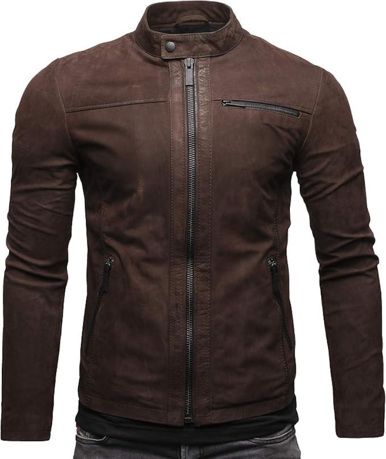 May include: A dark brown jacket with a matte finish, featuring a stand-up collar with a snap button closure, a central full-length zip, two slanted zipped pockets at the waist, and one horizontal zipped pocket on the upper left chest.