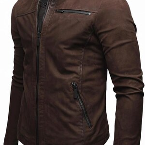 May include: A dark brown jacket with a stand-up collar, a full-length front zip, and long sleeves. The garment features a horizontal zipped chest pocket on the left side and two slanted zipped pockets at the waist, all with black hardware.