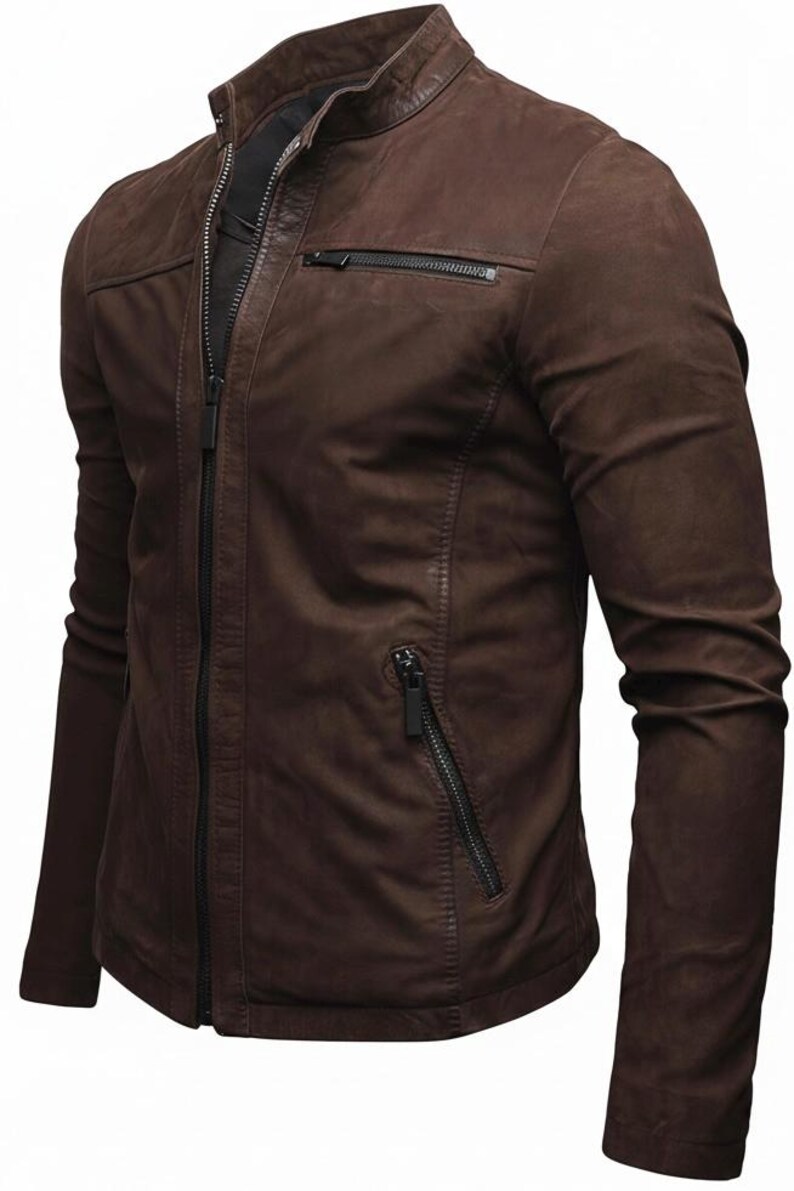 May include: A dark brown jacket with a stand-up collar, a full-length front zip, and long sleeves. The garment features a horizontal zipped chest pocket on the left side and two slanted zipped pockets at the waist, all with black hardware.