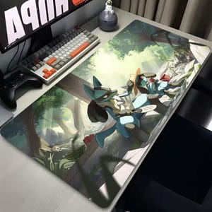 May include: Large rectangular gaming mousepad featuring a vibrant illustration of two anime-style characters in a forest setting. The characters are primarily blue and black, with a detailed background of trees and foliage. A keyboard and monitor are visible.