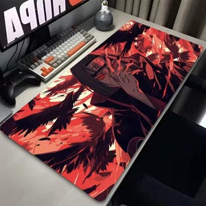 May include: A large rectangular mousepad featuring a detailed anime illustration in shades of red and black. The design includes a character with red eyes and crows, set against a fiery background. The mousepad is designed for gaming.