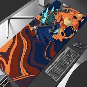 May include: A large rectangular mousepad featuring a vibrant design with orange, blue, and brown swirls. The pad showcases a cartoon illustration of several Charizard characters. A black keyboard and mouse are visible.
