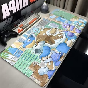 May include: A large rectangular mousepad featuring a colorful cartoon illustration of several blue and purple turtle-like creatures. The design includes a large blue turtle with a brown shell, and other smaller creatures. The background shows a beach scene.