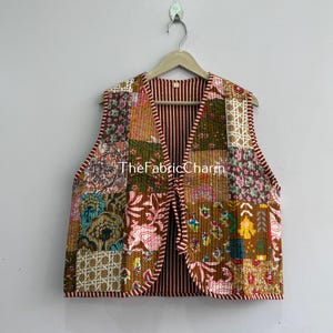 May include: A sleeveless vest featuring a patchwork design of various floral and geometric patterns in shades of brown, orange, pink, and green. The garment has a quilted texture and a red and white striped interior lining, with the text TheFabricCharm.