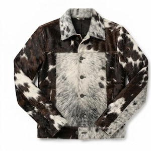 May include: A button-up jacket with a cowhide pattern. The jacket features a mix of brown, white, and black fur. The collar and front panel are a lighter shade of white and gray. The jacket has three buttons down the front.