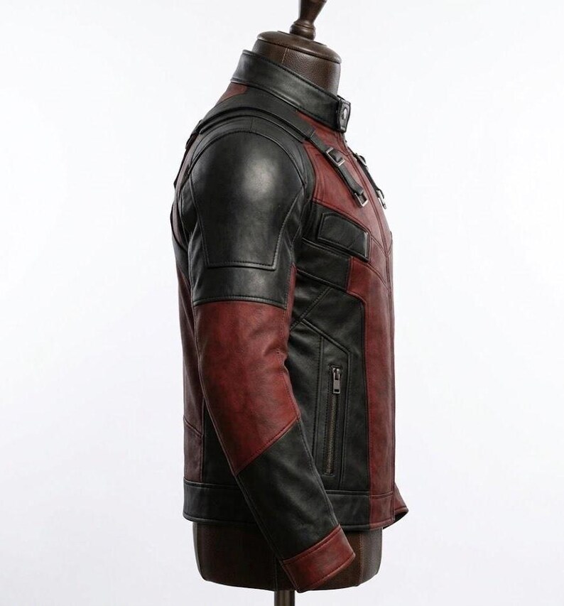 May include: A two-tone leather jacket in black and burgundy, displayed on a mannequin. The jacket features a stand-up collar, shoulder accents, and a zippered pocket. The sleeves are black, and the body is burgundy.