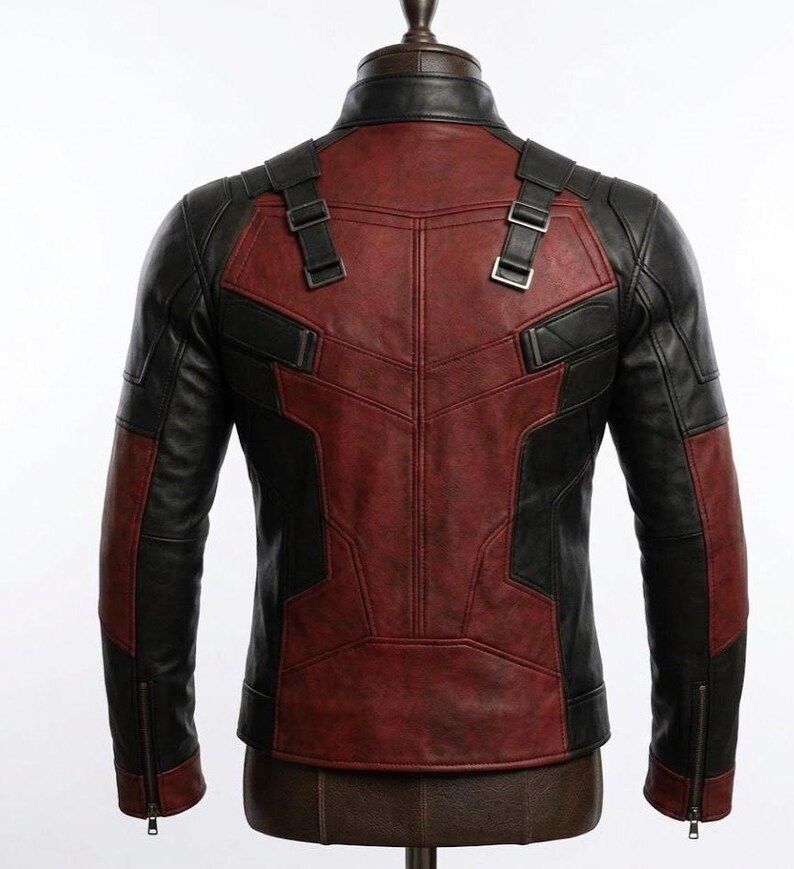 May include: A black and red leather jacket with a stand-up collar and zipper sleeves. The back of the jacket features a red panel design with black accents and adjustable straps. The jacket is displayed on a mannequin.
