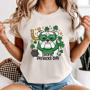 May include: A set of three ceramic mugs with a speckled, matte finish. Each mug features a different color: light blue, cream, and gray. The mugs have a simple, modern design and a comfortable handle.