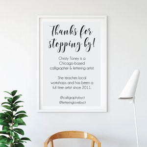 May include: A framed print with the text "Thanks for stopping by!" in elegant calligraphy. The print also includes information about Christy Toney, a Chicago-based calligrapher and lettering artist, and her social media handles.