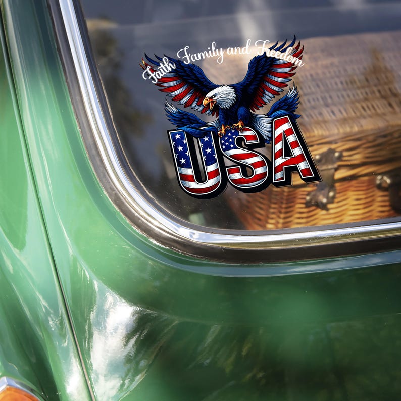 May include: A patriotic decal featuring a bald eagle with outstretched wings, the word "USA" in red, white, and blue, and the text "Faith Family and Freedom". The decal is affixed to a green vehicle.