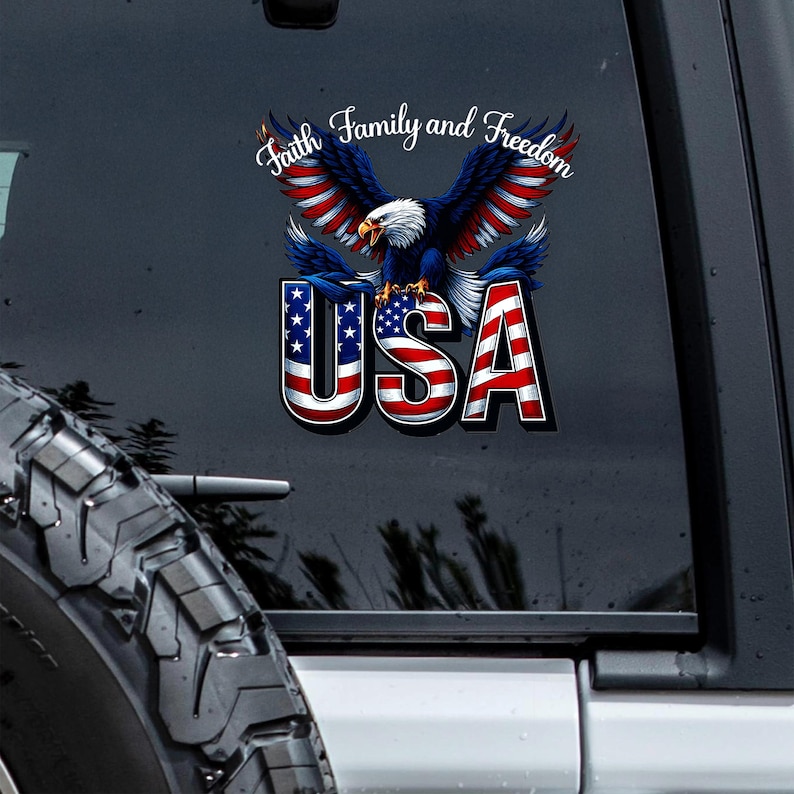 May include: A patriotic decal featuring a soaring bald eagle with outstretched wings, colored in red, white, and blue. The word "USA" is prominently displayed below the eagle, with the text "Faith, Family, and Freedom" above.