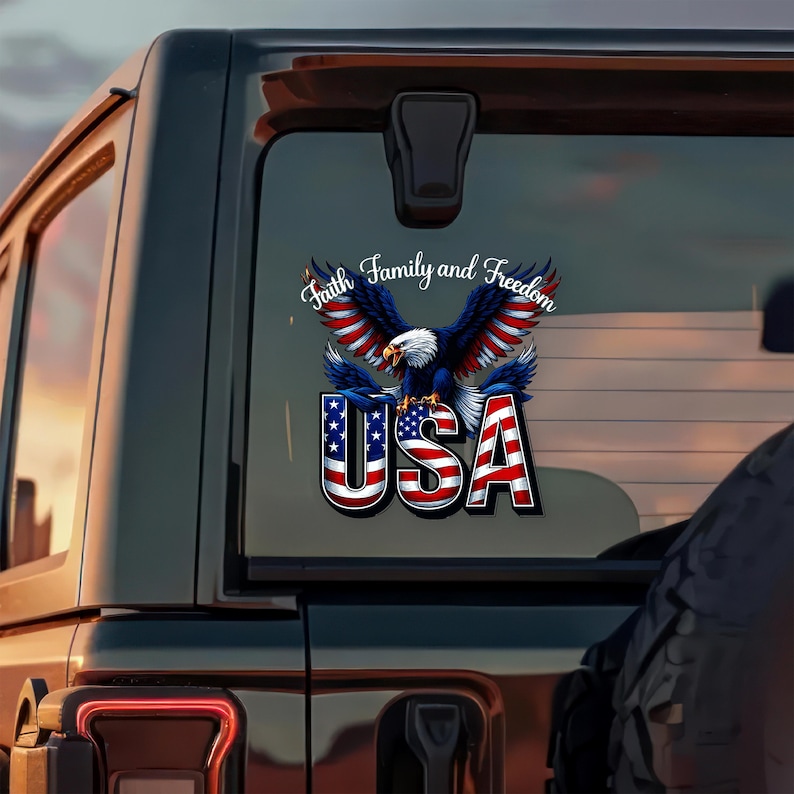 May include: A patriotic decal featuring a bald eagle with outstretched wings, colored in red, white, and blue. The word "USA" is prominently displayed below the eagle, with the words "Faith, Family, and Freedom" above.