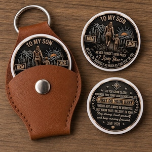 May include: A brown leather keychain pouch with a silver ring, containing a round metal coin with a mountain scene and the text TO MY SON MOM JACK NEVER FORGET HOW MUCH I LOVE YOU. Two additional identical coins are displayed nearby.