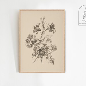 May include: A framed botanical print featuring a detailed black and white illustration of various flowers, including roses and lilies. The artwork is set against a beige background, with a wooden frame. The print is from the New York NYC Print Atelier.
