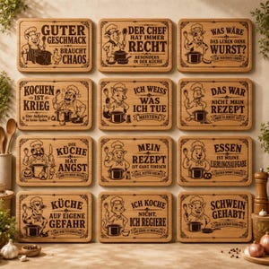 May include: A collection of twelve rectangular wooden cutting boards, each featuring a unique engraved illustration of an animal wearing a chef hat and holding a cooking utensil, accompanied by humorous German text related to cooking and kitchen life.