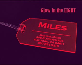May include: Red luggage tag with the name "MILES" and contact information for Michael Miles, including address and phone number. The tag glows in the dark.