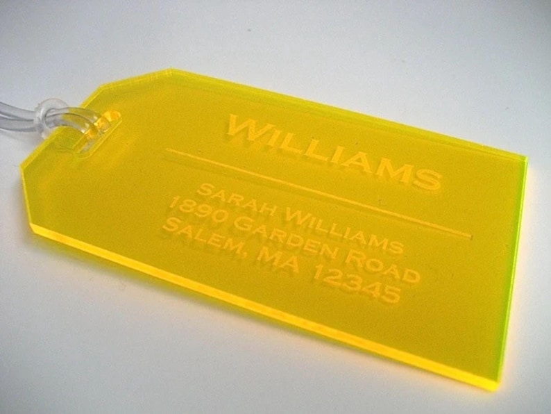 May include: Yellow luggage tag with the text "WILLIAMS" and "SARAH WILLIAMS 1890 GARDEN ROAD SALEM, MA 12345" embossed on it.