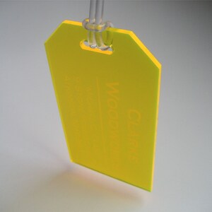 May include: A bright yellow plastic tag with a hole at the top and the word "Craft" printed on it.