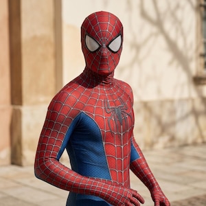 Close-up view of red and blue superhero bodysuit with detailed pattern and mask design.