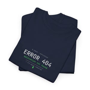 May include: Two navy blue t-shirts are stacked on top of each other. The top shirt has the text "ERROR 404 motivation not found" in white and green. The text is styled to look like a computer error message.