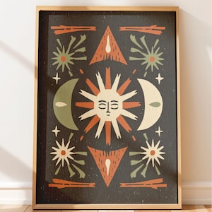 May include: A framed rectangular wall art print featuring a central sun face with closed eyes, surrounded by a crescent moon, stars, and geometric triangular shapes in a palette of dark charcoal, muted orange, sage green, and cream colors.