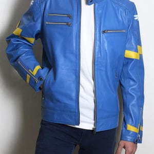 May include: A bright blue leather jacket featuring a mandarin collar, silver-toned metal zippers on the chest and sleeves, and yellow horizontal stripes on the arms. The jacket includes white wing-shaped emblems on the shoulders and a yellow inner lining.