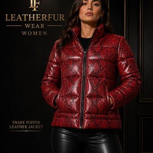 May include: A red puffer jacket with a black snake skin pattern, featuring a high collar, a central black zip, and two side pockets. The text LEATHERFUR WEAR WOMEN and SNAKE PUFFER LEATHER JACKET is visible on the dark background.