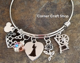 PRINCESS SLEEPING BEAUTY Aurora Inspired Bangle Charm Bracelet Pink glass bead, Crown Charm   Spinning Wheel Rose Option to personalize name