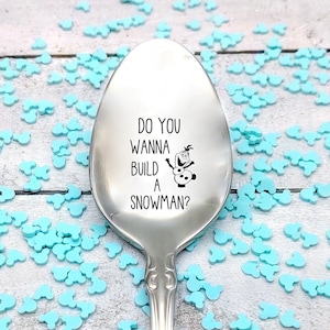 May include: A silver spoon with the text "Do you wanna build a snowman?" and an image of Olaf from the movie Frozen.