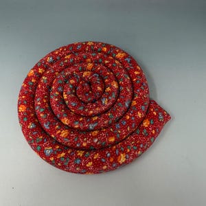 May include: A set of three ceramic mugs with a speckled, matte finish. The mugs are in shades of cream, light gray, and dark gray. Each mug has a simple, minimalist design, perfect for coffee or tea.