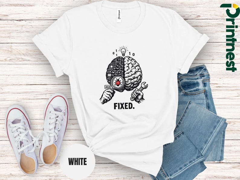 May include: A white t-shirt featuring a black and white graphic of a brain split between a circuit board and organic tissue. One hand holds a magnifying glass over a red bug, while the other holds a wrench. Above is a lightbulb and binary code, with the text FIXED below.