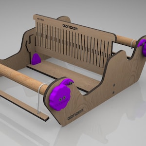 May include: A wooden weaving loom with a natural finish, featuring wooden dowels, purple knobs, and the word "GANDER" printed on the frame. The loom is designed for crafting and textile projects.