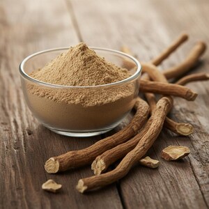 May include: A clear glass bowl filled with light brown powder sits on a wooden surface, alongside several brown, dried roots. The roots are of varying lengths and textures. The background is a rustic wooden table.