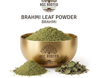 May include: A gold-toned bowl filled with fine green Brahmi leaf powder, featuring the RGC Rooted Organic Goods tree logo. A small pile of the same green powder and a cluster of dried Brahmi leaves sit in front of the bowl on a white background.