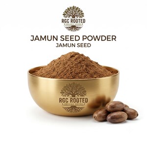 Puede incluir: Un cuenco de metal dorado lleno de polvo de semillas de jamun, con el logotipo de RGC ROOTED ORGANIC GOODS. El texto JAMUN SEED POWDER y JAMUN SEED aparece sobre el cuenco, con varias semillas de jamun enteras colocadas al lado.