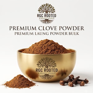 May include: A gold-toned metal bowl filled with brown clove powder, featuring the RGC ROOTED ORGANIC GOODS tree logo. Text reads PREMIUM CLOVE POWDER and PREMIUM LAUNG POWDER BULK. A small pile of powder and several whole cloves sit beside the bowl.