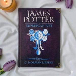 May include: A hardcover book titled James Potter and the Morrigan Web by G. Norman Lippert. The dark purple cover features silver text and a central graphic of blue clock faces and ornate shapes. The book has gold-toned metal corner protectors.