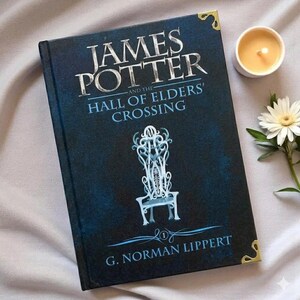 May include: A hardcover book titled James Potter and the Hall of Elders' Crossing by G. Norman Lippert. The dark blue cover features a white illustration of an ornate chair, silver lettering, and gold-toned metal corner protectors.