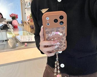 Funda de cuero rosa y marrón con estampado de leopardo de Hello Kitty con cordón para iPhone 17 Pro, 16 Pro Max y serie 15.