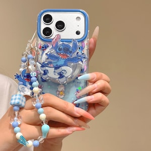 May include: A clear phone case with a blue border and a Stitch design. The case features a blue and white beaded strap. The design includes the text "Blue Stitch".