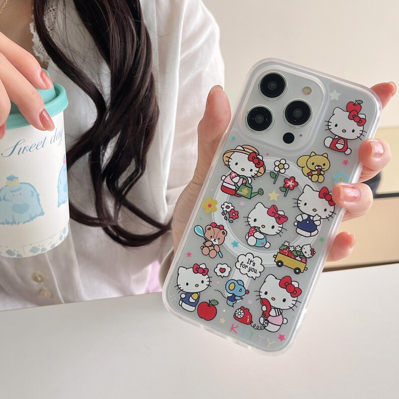 May include: Clear phone case featuring multiple Hello Kitty character designs with red bows and various accessories. The case has a glittery background and includes the text "It's for you."