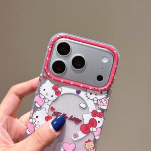 May include: Clear phone case with a Hello Kitty design. The case has a pink and white polka dot border and a clear centre with Hello Kitty illustrations. The text "Hello Kitty" is visible on the case.