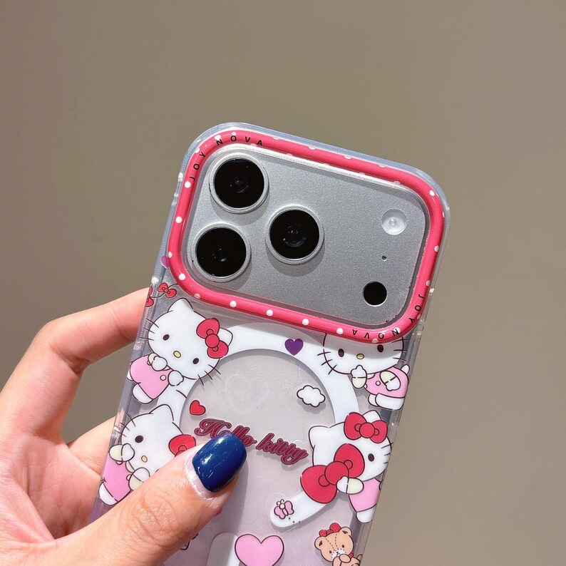 May include: Clear phone case with a Hello Kitty design. The case has a pink and white polka dot border and a clear centre with Hello Kitty illustrations. The text "Hello Kitty" is visible on the case.