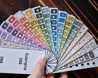 May include: A hand holds a fan of colour swatches, each displaying a unique hue and number. The swatches range from vibrant reds and oranges to cool blues and greens. A white card with the number "288" and the name "Guangna" is also visible.