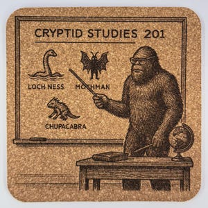 May include: A cork coaster with the text "CRYPTID STUDIES 201" and illustrations of the Loch Ness Monster, Mothman, and Chupacabra. A Bigfoot-like figure with glasses stands at a chalkboard, pointing with a stick.