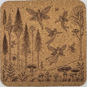 May include: A square cork coaster with a detailed forest scene. The design features tall trees, mushrooms, and several fairies with outstretched wings. The artwork is in shades of brown, creating a natural and whimsical aesthetic.