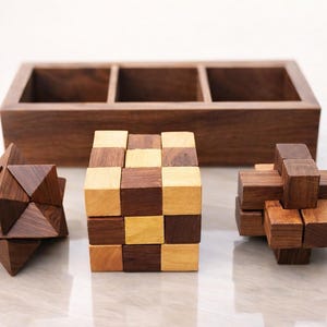 May include: A selection of wooden puzzle toys in geometric shapes, including a star, a cube, and a cross. A wooden box with three compartments is in the background. The puzzles are made of different shades of brown wood.