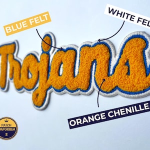 May include: An orange chenille patch with the word "Trojans" in a script font. The patch has a blue felt outline and white felt border. The patch is from Patch Emporium.